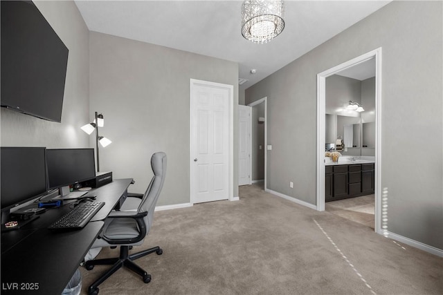 office area with a notable chandelier, light colored carpet, and baseboards