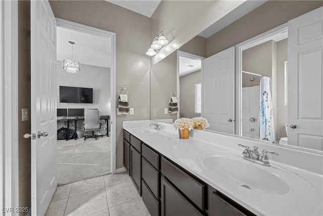 bathroom with double vanity, tile patterned flooring, a sink, and toilet