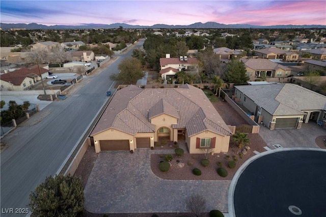 aerial view at dusk featuring a residential view