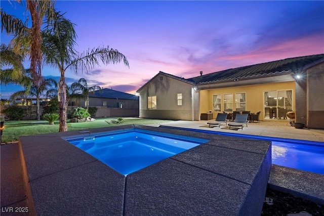 view of pool with a patio, fence, a jacuzzi, and a fenced in pool