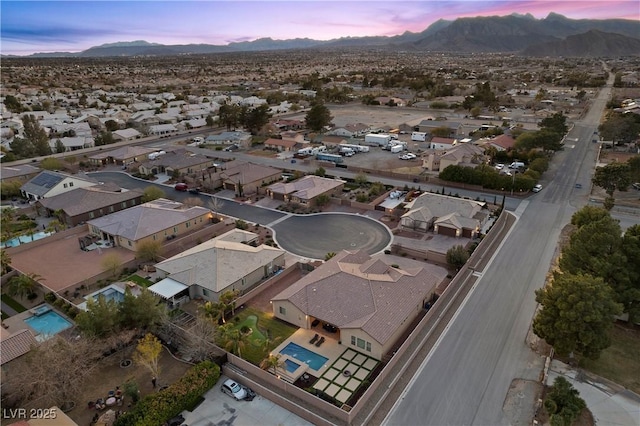 aerial view at dusk with a residential view and a mountain view