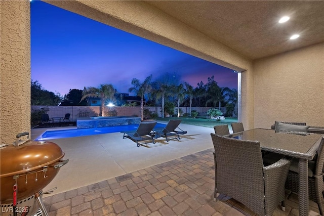 view of patio / terrace featuring outdoor dining space, a fenced backyard, and a fenced in pool