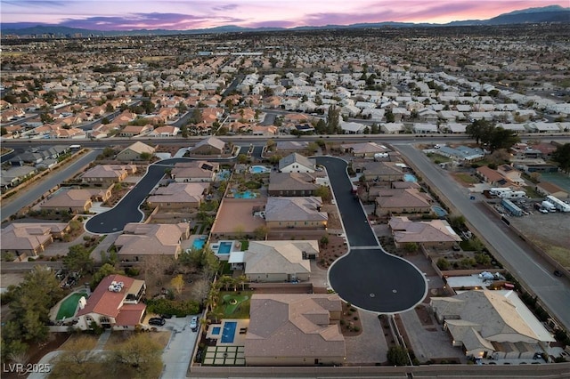 aerial view at dusk with a mountain view and a residential view