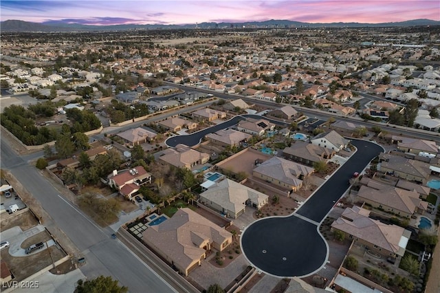 aerial view at dusk with a residential view and a mountain view