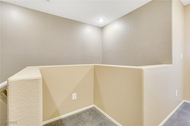 interior space featuring carpet flooring and baseboards