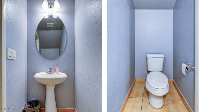 bathroom with toilet, baseboards, and tile patterned floors