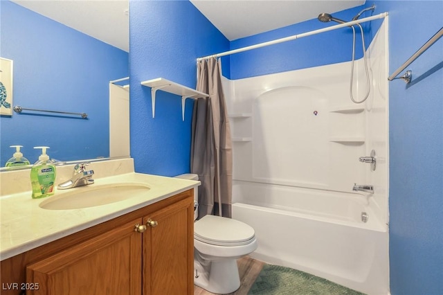 full bathroom with a textured wall, shower / bath combo with shower curtain, vanity, and toilet