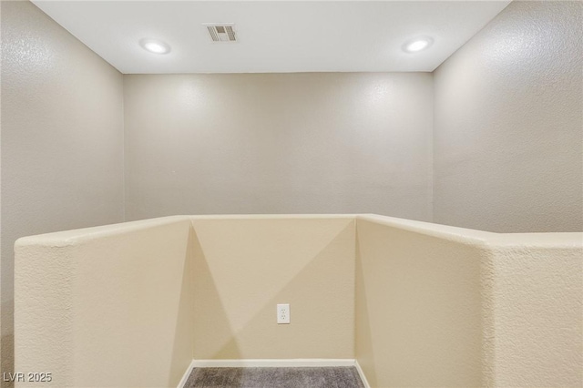 interior space with carpet floors, recessed lighting, visible vents, and baseboards