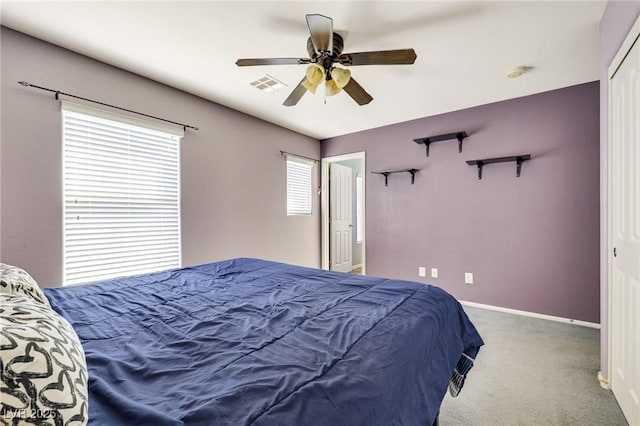 bedroom featuring carpet floors, visible vents, baseboards, and a ceiling fan