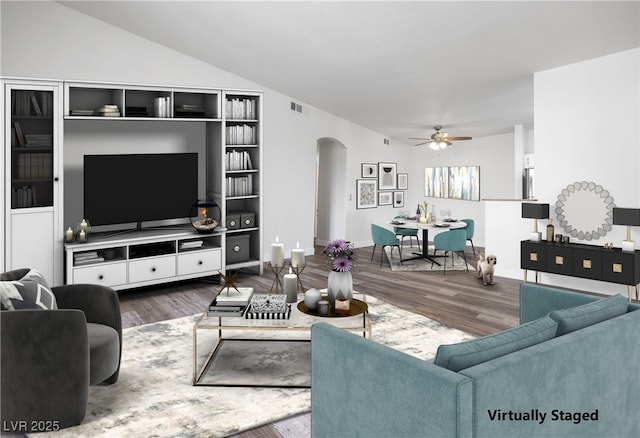 living area featuring arched walkways, ceiling fan, wood finished floors, and visible vents