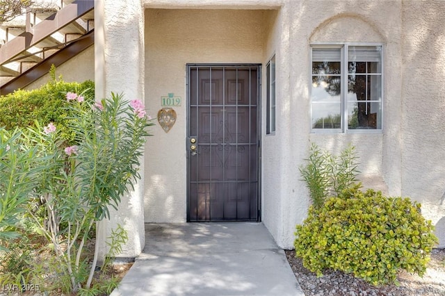 doorway to property with stucco siding