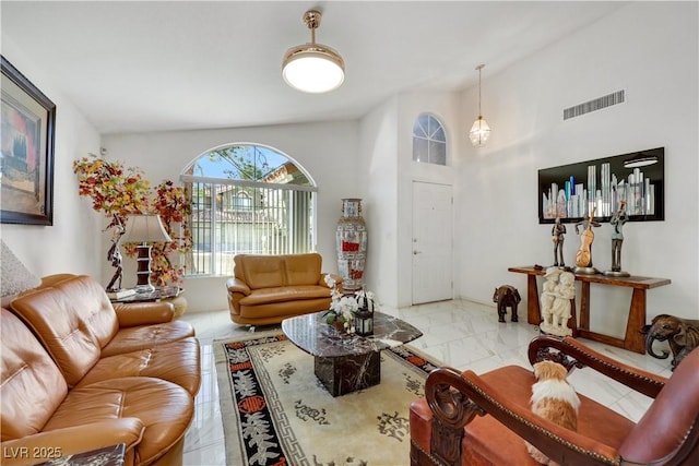 living area with marble finish floor and visible vents