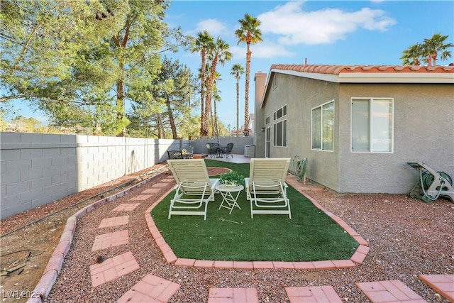 view of yard featuring a patio area and a fenced backyard