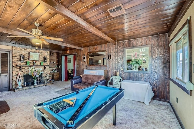 recreation room featuring wooden ceiling, wood walls, visible vents, baseboards, and beamed ceiling