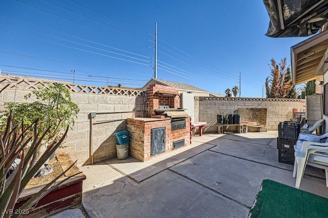 view of patio / terrace with grilling area, an outdoor kitchen, and a fenced backyard