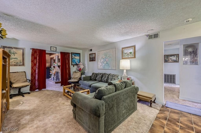 living room with carpet, visible vents, and a textured ceiling