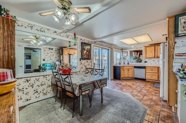 tiled dining space with ceiling fan, crown molding, and wallpapered walls