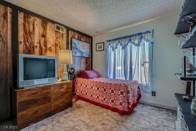 bedroom with visible vents, a textured ceiling, and light colored carpet