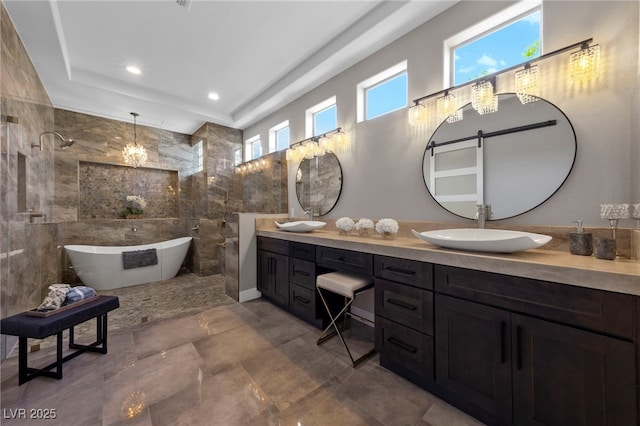 bathroom with double vanity, recessed lighting, a sink, a freestanding tub, and tiled shower