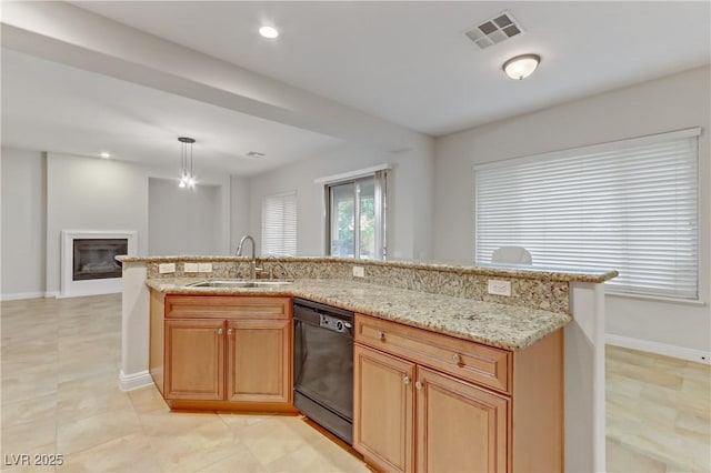 kitchen with decorative light fixtures, visible vents, a glass covered fireplace, a sink, and dishwasher