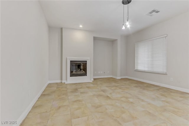 unfurnished living room featuring recessed lighting, baseboards, visible vents, and a glass covered fireplace