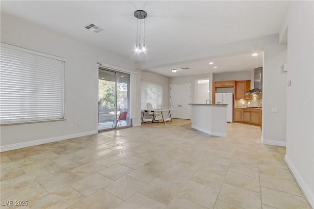 unfurnished living room featuring recessed lighting, visible vents, and baseboards