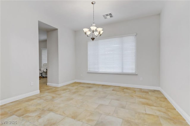 unfurnished room with a chandelier, visible vents, and baseboards