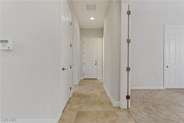 hall with recessed lighting, visible vents, light carpet, and baseboards