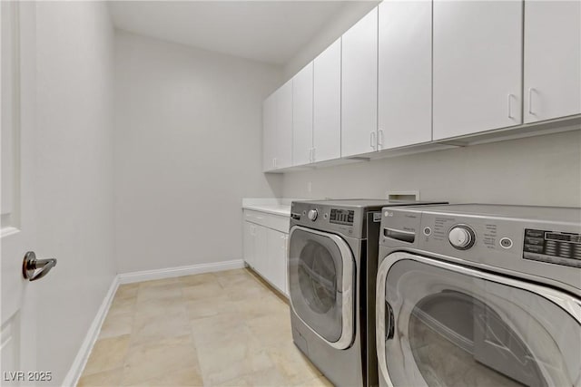 laundry room with cabinet space, independent washer and dryer, and baseboards