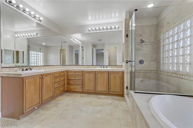 full bath with double vanity, a stall shower, a sink, and a bath