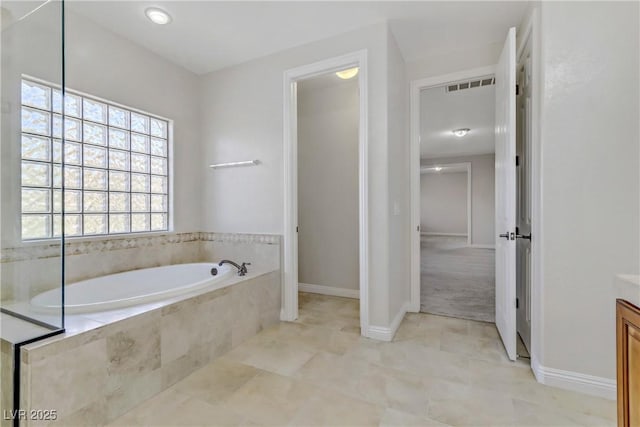 full bathroom featuring baseboards, visible vents, a bath, and vanity