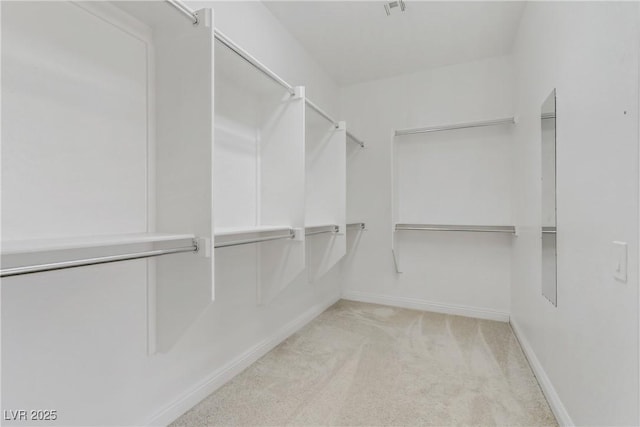 walk in closet with light carpet and visible vents