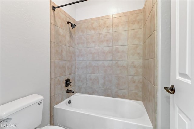 bathroom with toilet and shower / bathing tub combination