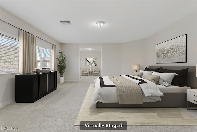 bedroom with light colored carpet, visible vents, and baseboards