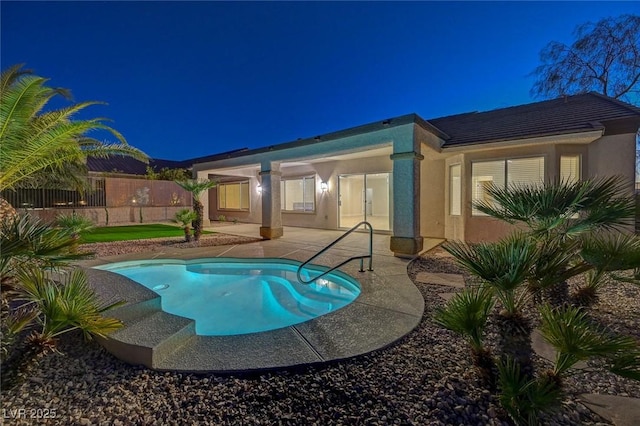 pool at twilight with a patio, fence, and a fenced in pool