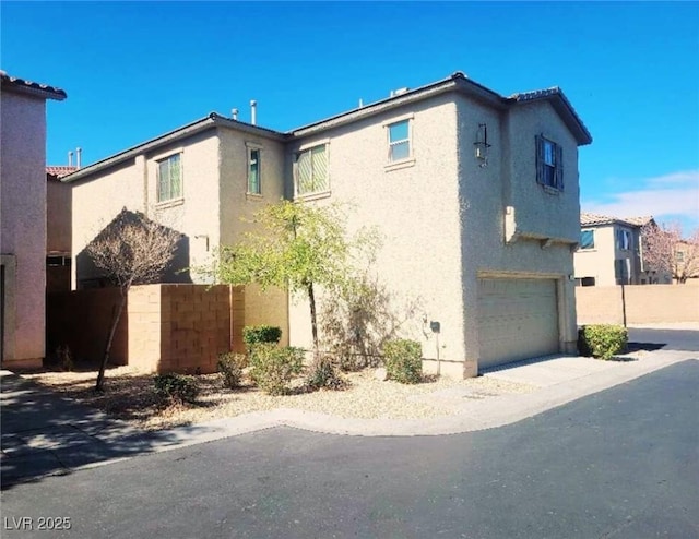 view of property exterior with a garage and stucco siding