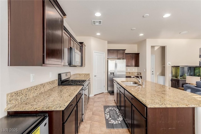 kitchen featuring a center island with sink, recessed lighting, visible vents, appliances with stainless steel finishes, and a sink