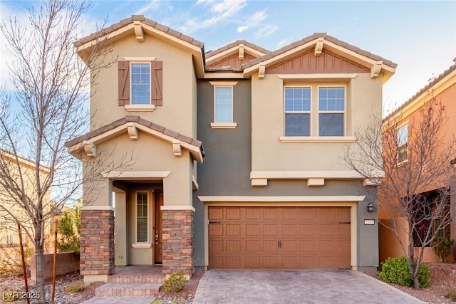 view of front of home featuring a garage, decorative driveway, a tiled roof, and stucco siding