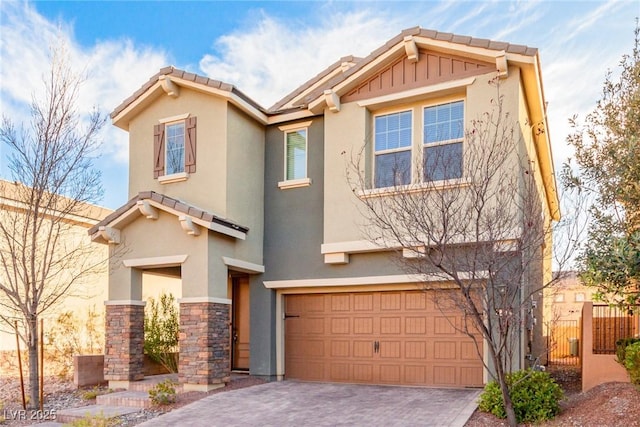 view of front of house with an attached garage, stone siding, decorative driveway, and stucco siding