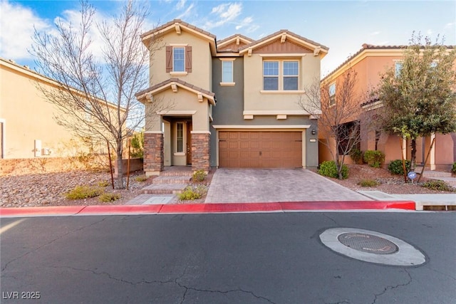 view of front of house featuring decorative driveway, a tile roof, stucco siding, an attached garage, and stone siding