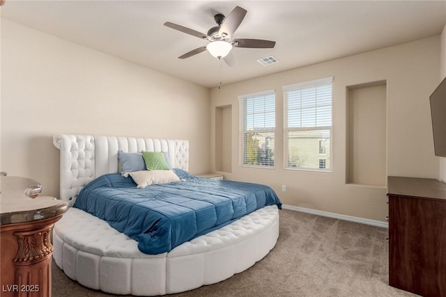 bedroom featuring baseboards, a ceiling fan, visible vents, and light colored carpet