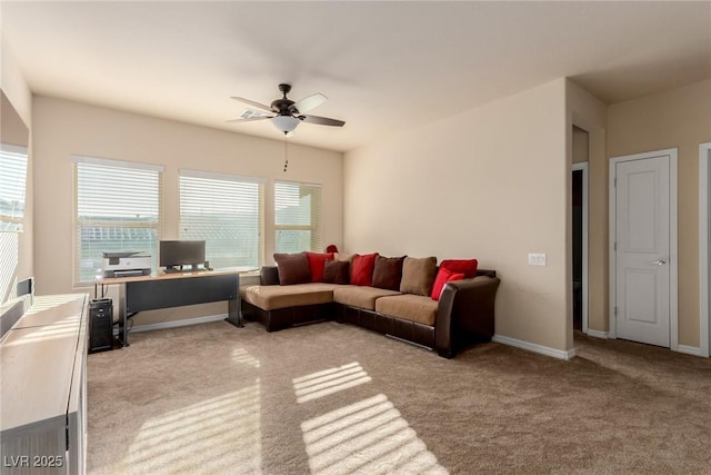 living room featuring light carpet, ceiling fan, and baseboards