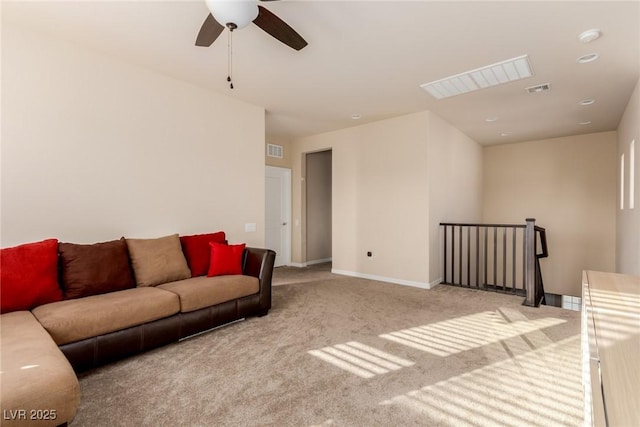 living room with baseboards, a ceiling fan, visible vents, and light colored carpet