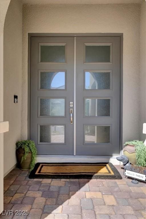 property entrance with stucco siding