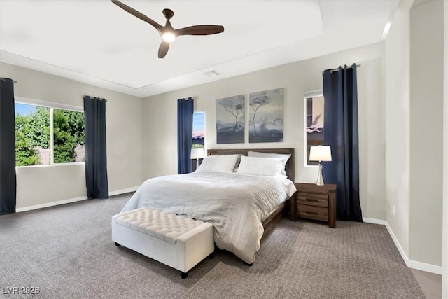 carpeted bedroom with ceiling fan and baseboards