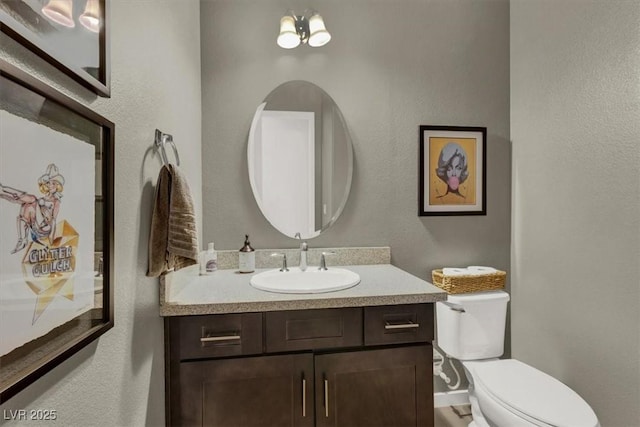 bathroom with toilet and vanity