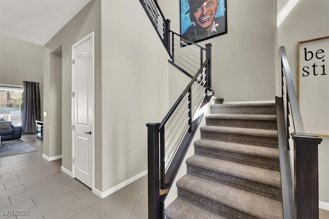 stairs with wood finished floors and baseboards