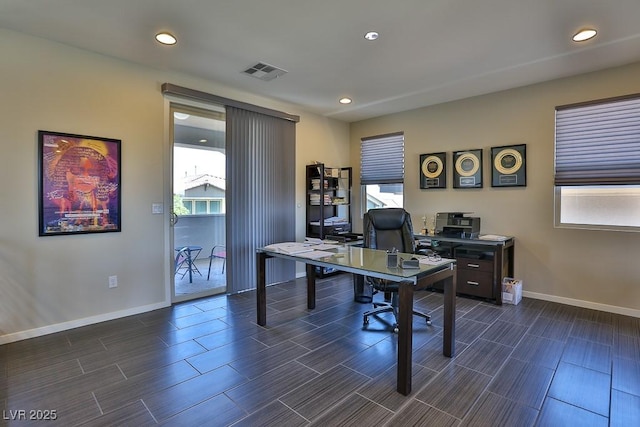 office space with wood tiled floor, recessed lighting, visible vents, and baseboards