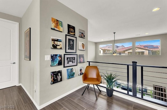 sitting room featuring recessed lighting, wood tiled floor, and baseboards