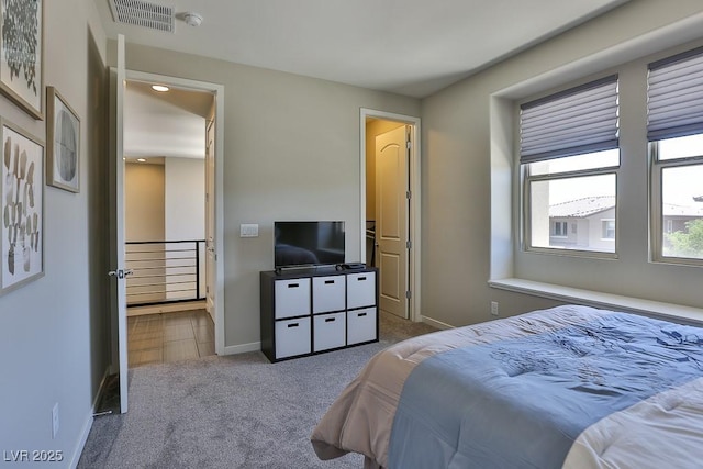 carpeted bedroom with baseboards and visible vents